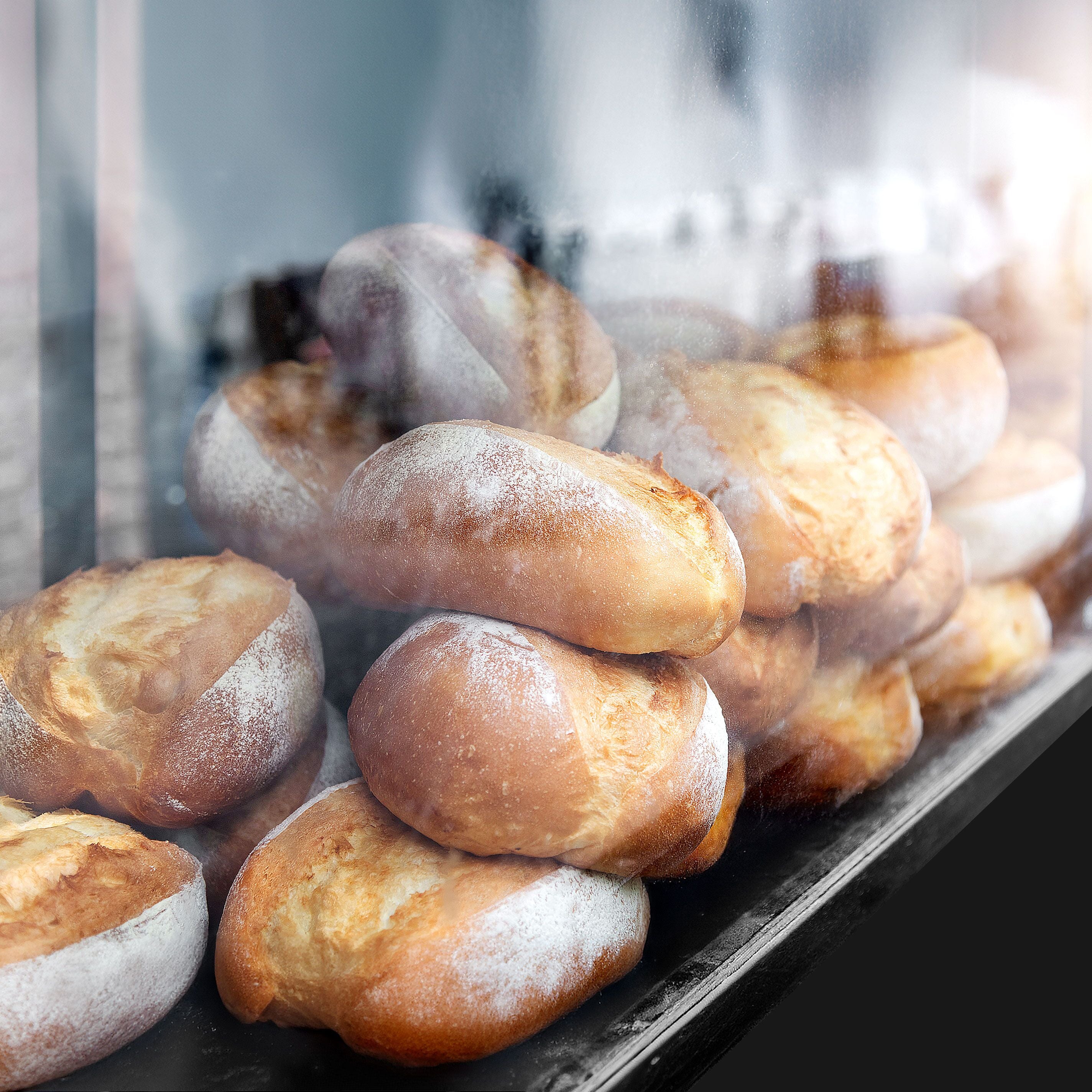 Assortment of baked bread on shelves.